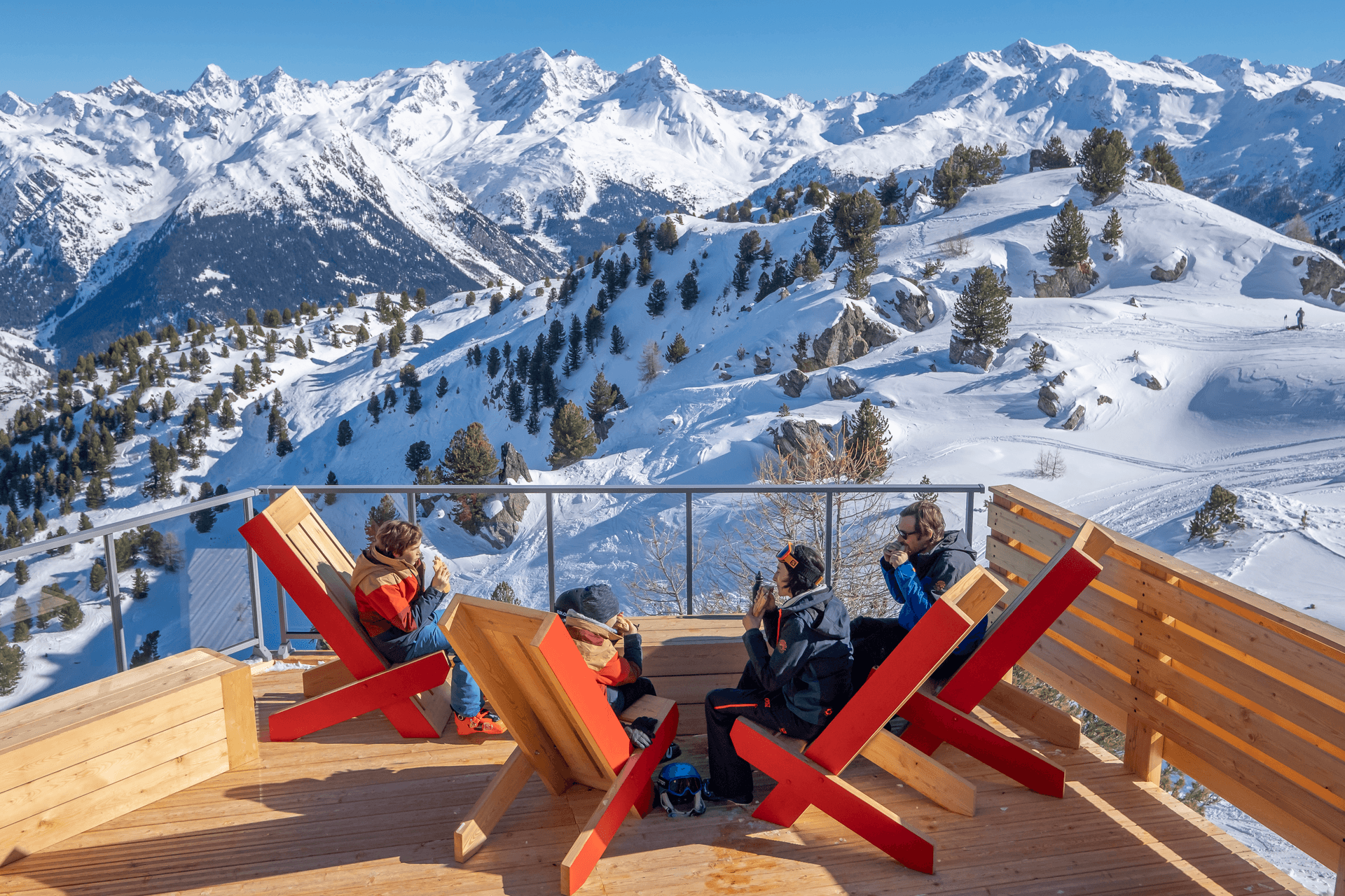 Family of skiers taking a break to eat lunch above Les Arcs ski resort